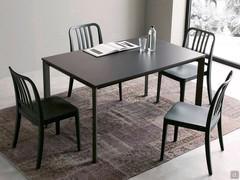 Main extending dining table with triangular metal legs painted in charcoal colour, coordinated to the glass top and chairs (legs model not available).