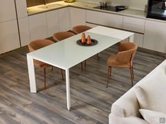 Table Main with 50-cm extension in white melamine "in use": allows you to comfortably add two extra seats at the table