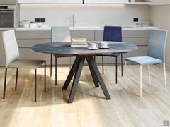 Dining table Station here pictured in a modern kitchen. The central folding extensions grant extra seats in just a few steps.