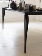 Close up of the table with black sabre-shaped legs moulded in black copolymer