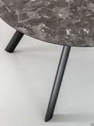 Detail of the round layered HPL melamine top and slender painted metal legs