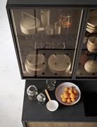 Detail of the elegant showcase wall units with burnished frame and smoked glass, interior led lighting