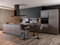 Kitchen with big cooking area and integrated snack bar counter,  with two-tone cabinets and wall units