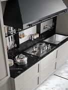 The top features a deep splashback that can be used as a countertop, complemented by wall-mounted equipped panel