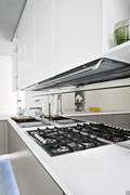 Working area with stove and sink with integrated cutting boards