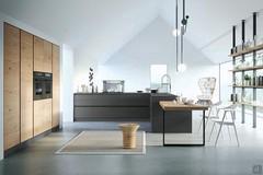 Front view of the matte lacquered kitchen island and sink with the peninsula table in the foreground