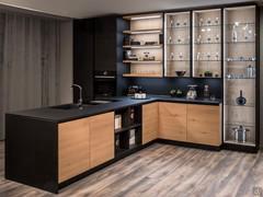 Kichen with central peninsula equipped with storage cabinets, sink, top and induction hob