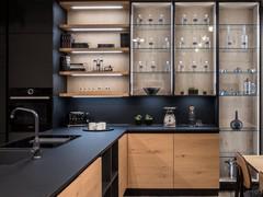 Detail of the display cases and wall units with glass doors matched with wooden shelves