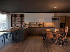 Large custom-made peninsula kitchen with built-in wooden snack top