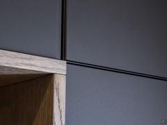 Detail of the door with aluminium frame and and black etched glass