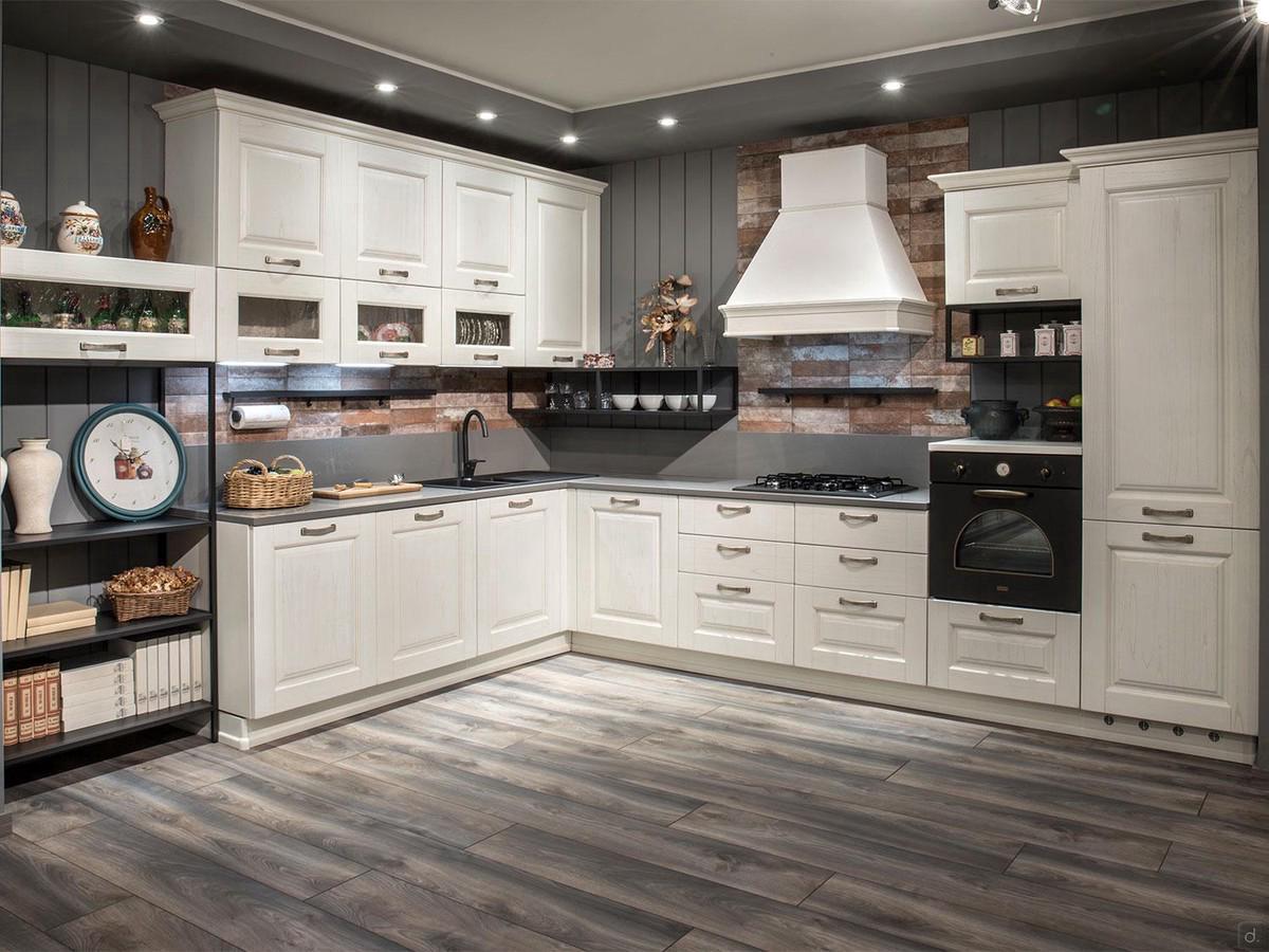 Classic corner-base white kitchen with pickled wood framed doors. Black sink, fires and oven, encased fridge, cupboards with showcases and chimney hood (handle model no longer available) 