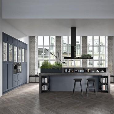 Island kitchen with sink and stove in the middle of the room, snack counter and separate columns