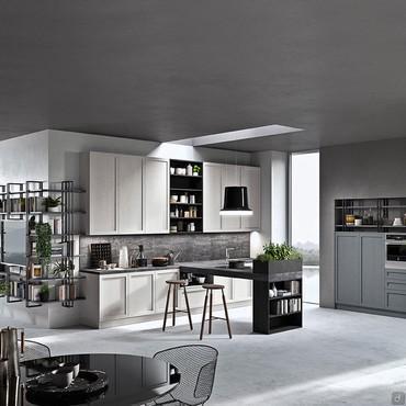 Kitchen with center peninsula with cooktop and snack counter, large countertop with wall-mounted sink, wall cabinets and half columns pantry, oven and refrigerator