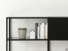 Open compartments with shelves delicately set flush at the top in the metal frame