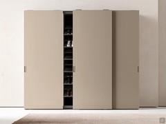 Example of sliding wardrobe with central module fully equipped with shoe shelves. Interior in brown oak melamine and jute matt lacquered fronts. 