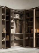 Space-saving corner wardrobe with folding doors Driver Wide, available not only in glass (as in photo), but also with doors in melamine, matt lacquer or wood