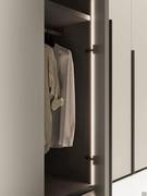 Detail of the interiors of the Focus Wide wardrobe, with titanium finish hinges, veneered or matt lacquered interiors and optional vertical LED along the dividing sides