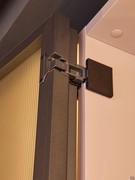 Detail of the hinges in moka shine finish allowing a generous opening for the Arctic hinged door