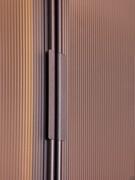 Detail of the painted metal handles of the Arctic Wide hinged wardrobe, they match the metal profile framing the door