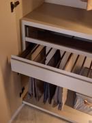 Pull-out trouser rack with groove opening. Combined with drawer with glass front