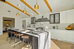 Kitchen with island with snack counter and sink integrated into the top