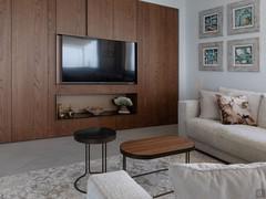 The bespoke wooden wall unit has a TV compartment and a horizontal open niche.