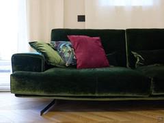 Sofa with comfortable seat, wide arms; resting on sled feet.