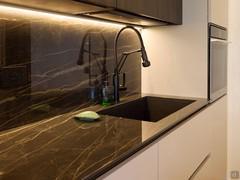 Noir Desir polished laminam stone kitchen countertop. Black undermount sink.