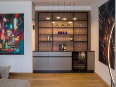 Bar area with large back equipped with shelves, floor storage, undertop wine cellar