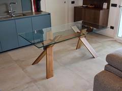 Table with national walnut wood trestle legs and natural clear glass top