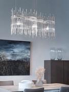 3-light Diadema pendant lamp with crystal rods of different sizes hanging on a metal frame