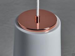 Detail of the fabric cable attachment to the white and copper diffuser