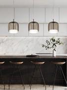 Lamps Jube suspended above the peninsula top in white and smoked double-glazed version