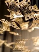 Suspended leaves detail in 24-carat gold-plated brass made by chemical photoengraving and electrolytic gilding. Supported by transparent nylon cables.