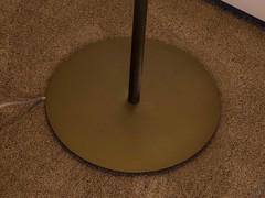 Detail of the matte stone bronze base of the Miss designer floor lamp