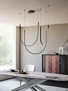 Nahun slim steel pendant lamp by Cattelan above the Lancer table