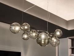 Detail of the satin-finished black nickel metal ring structure onto which the spherical blown glass lampshades are fixed