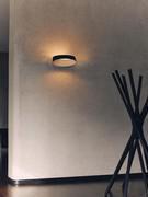 Oxygen wall lamp with black edge and white interior. Also available for other placements, in different colours