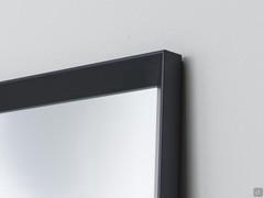 Details of the Plain frame, one of three available on the mirror Tema. Here offered in a black lacquer finish.