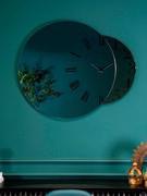 Fusion clock mirror, the smaller surface is available in a bronze or smoked finish.