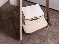 Close up of the upholstered storage tray, a useful feature of the Narvik coat stand mirror