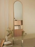 Domu mirror with upper arc-shaped profile, here pictured in natural ash