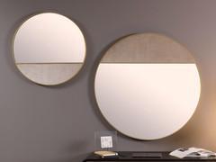 Composition of the Cayos round mirror in brass with one part covered in Elina velvet