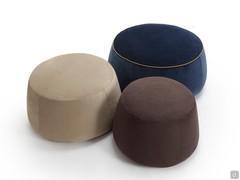 Set of three round footstools covered in three different fabrics