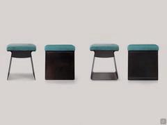 Couple of Calvin pouffe stools with open and closed metal strcutures and cushions upholstered in leather