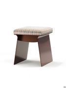 The Calvin pouffe stool with an open metal structure and seat cushion upholstered in fabric