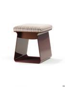 The Calvin pouffe stool with a closed metal structure and seat cushion upholstered in fabric