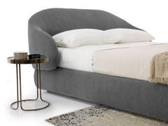 Detail of the curved, enveloping headboard of the Kalin outlet bed