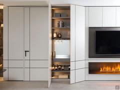 Lacquered wooden doors with special vertical and horizontal effects conceal a precious concealed bar cabinet