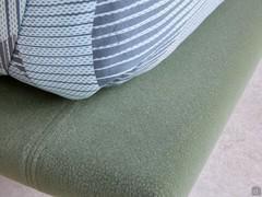 Detail of the bed frame in Carabu col.49 fabric, a forest green shade.